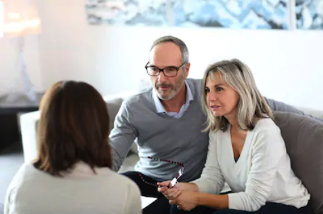 Couple consulting with female advisor